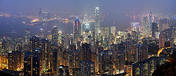 A panorama overlooking the skyscrapers of Hong Kong at night, with Victoria Harbour in the background